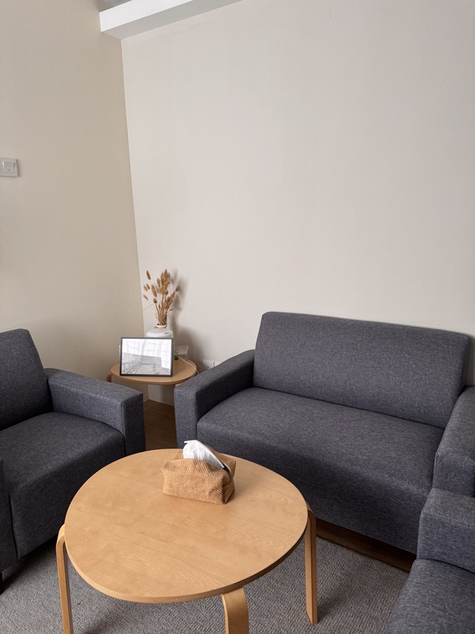 Grey sofa seating arranged around a table